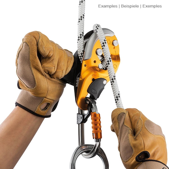 Les mains en gants de travail marron actionnent le matériel d’escalade I’D S de Petzl avec corde blanche et mousqueton