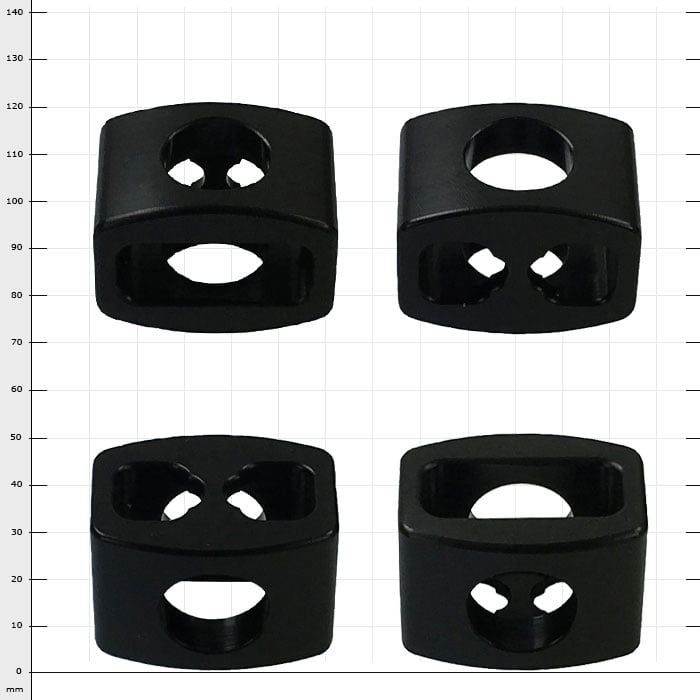 Pièces en plastique noir StopperGate avec différents trous, quatre pièces sur fond de grille blanche