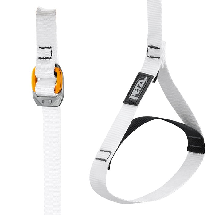 Gros plan de la bande inférieure blanche Knee Ascent Loop avec fermeture jaune-gris, logo PETZL noir et rembourrage noir sur la partie inférieure de la bande