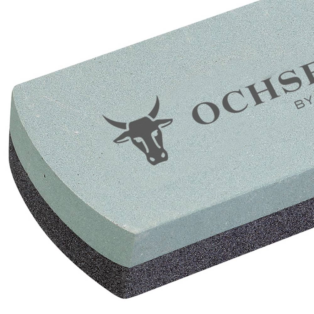 Gros plan de la meule en carbure de silicium, focus sur la surface gris clair avec l’inscription « OCHSENKOPF BY GEDORE » et le logo de la tête de taureau