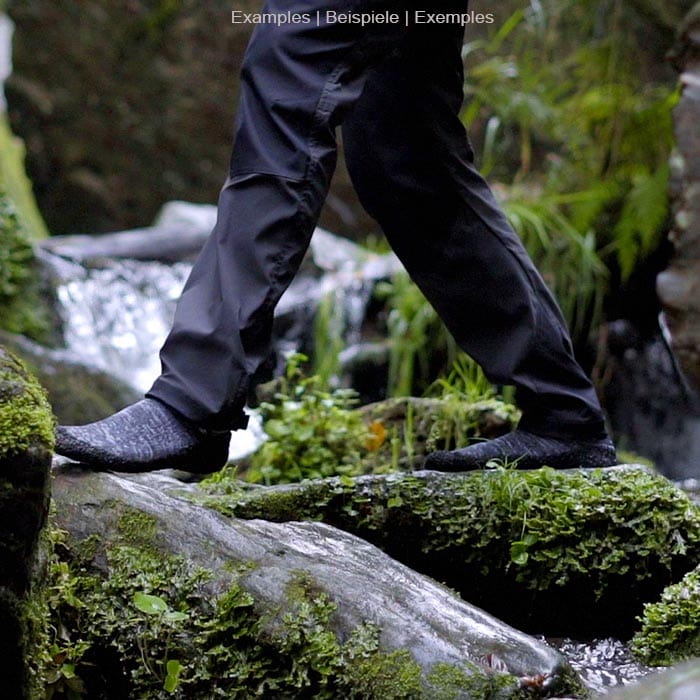 Chaussette grise de Skinner à semelle noire sur un pied posé sur une pierre recouverte de mousse dans la nature