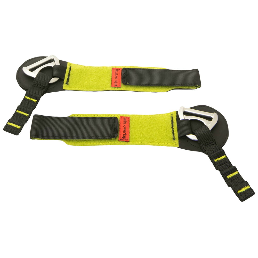 Reliure inférieure Talon, deux sangles jaunes et noires avec anneaux en D métalliques et patchs rouges avec l’inscription « min. overlap ».