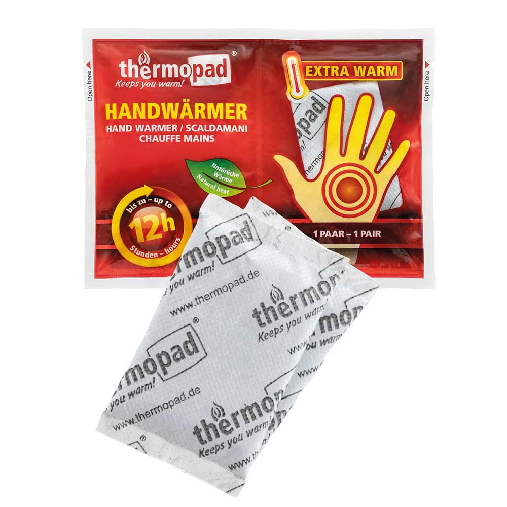 Chauffe-mains de thermopad dans un emballage rouge avec des graphiques de main jaunes et un coussin chauffant blanc avec impression de thermopad devant lui